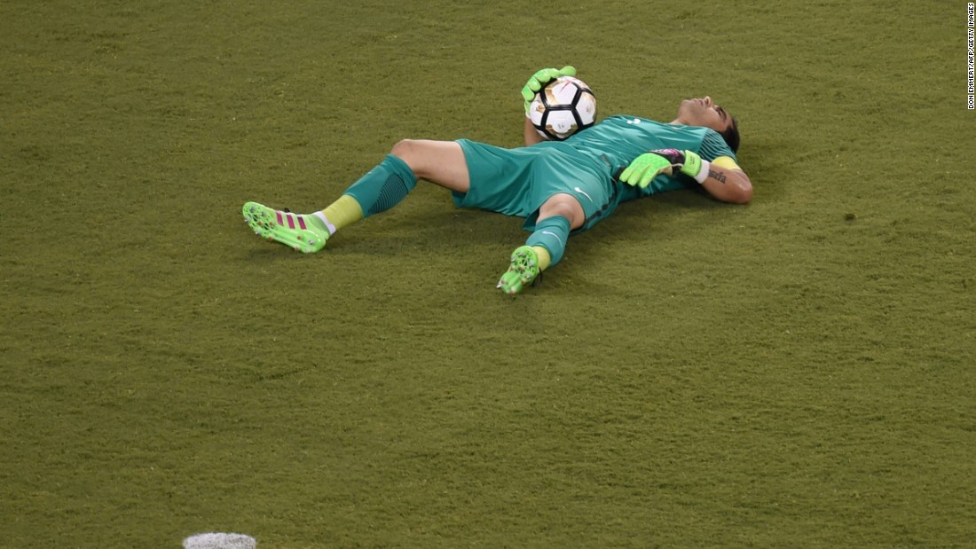 Chile&#39;s goalkeeper Claudio Bravo lies on the ground.