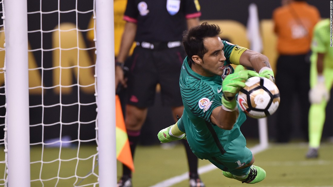Chile&#39;s goalie Claudio Bravo stops a shot by Argentina&#39;s Lucas Biglia (out of frame).