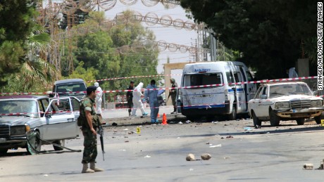 Lebanese security forces secure the site of the suicide attacks early on June 27.