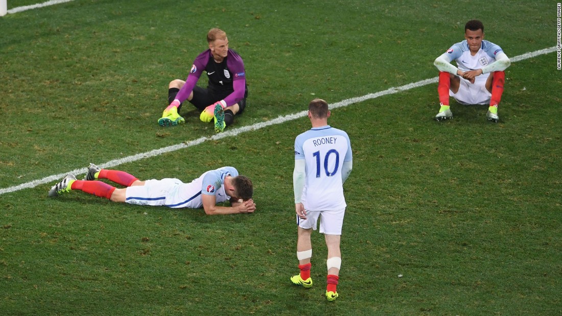 Wayne Rooney walks over to console his teammates -- from left, Gary Cahill, Joe Hart and Dele Alli -- after England were upset 2-1 by Iceland on Monday, June 27. Iceland will play France in the tournament&#39;s quarterfinals. England has been eliminated.