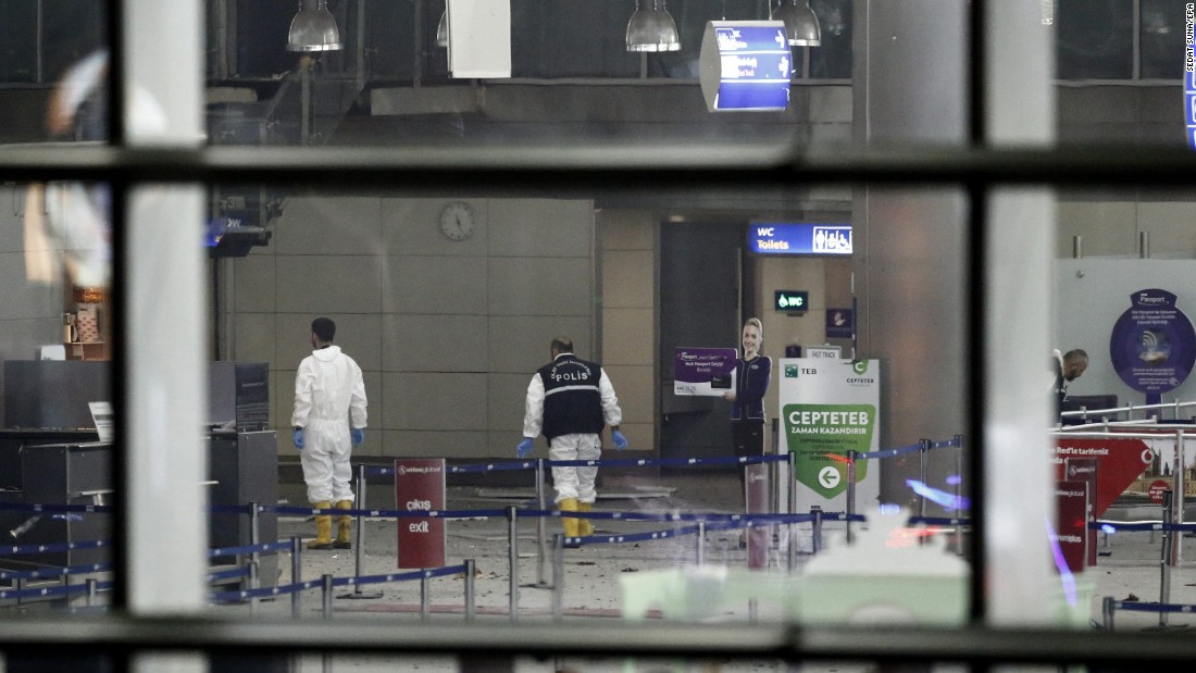 Police investigators work inside the airport. 