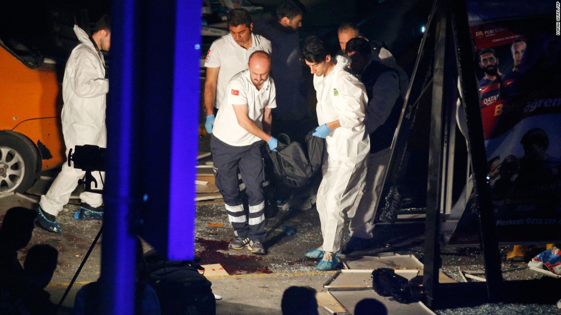Investigators remove a body after the attack.