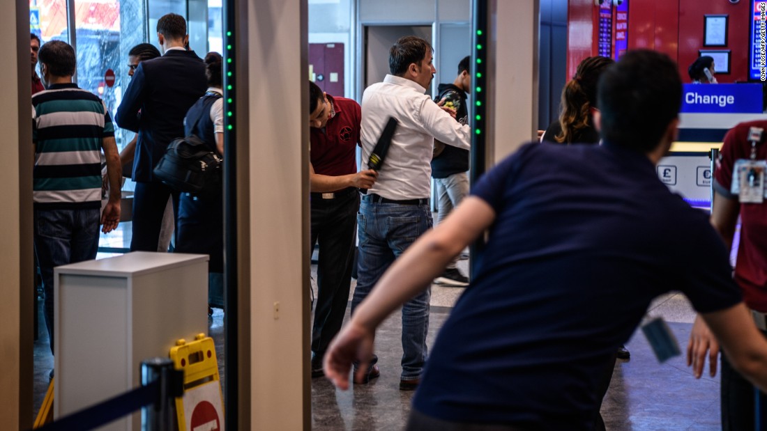 Security personnel scan passengers and employees at a checkpoint on June 29.