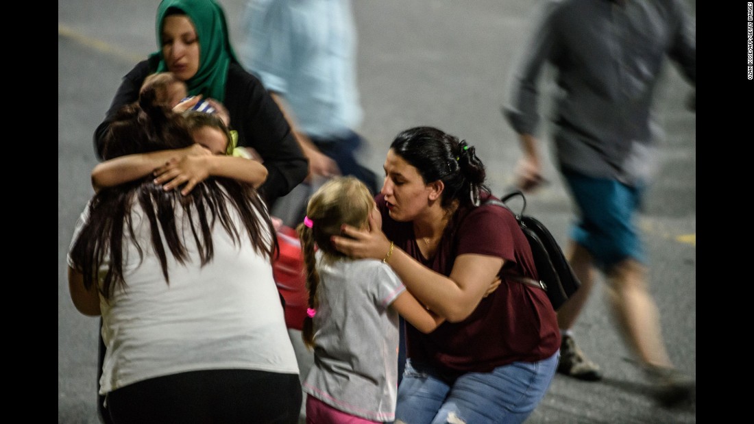 Children and their relatives embrace after reuniting outside the airport.