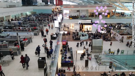 Passengers pass through the security check and walk through the shops inside Terminal 5 at Heathrow Airport. 