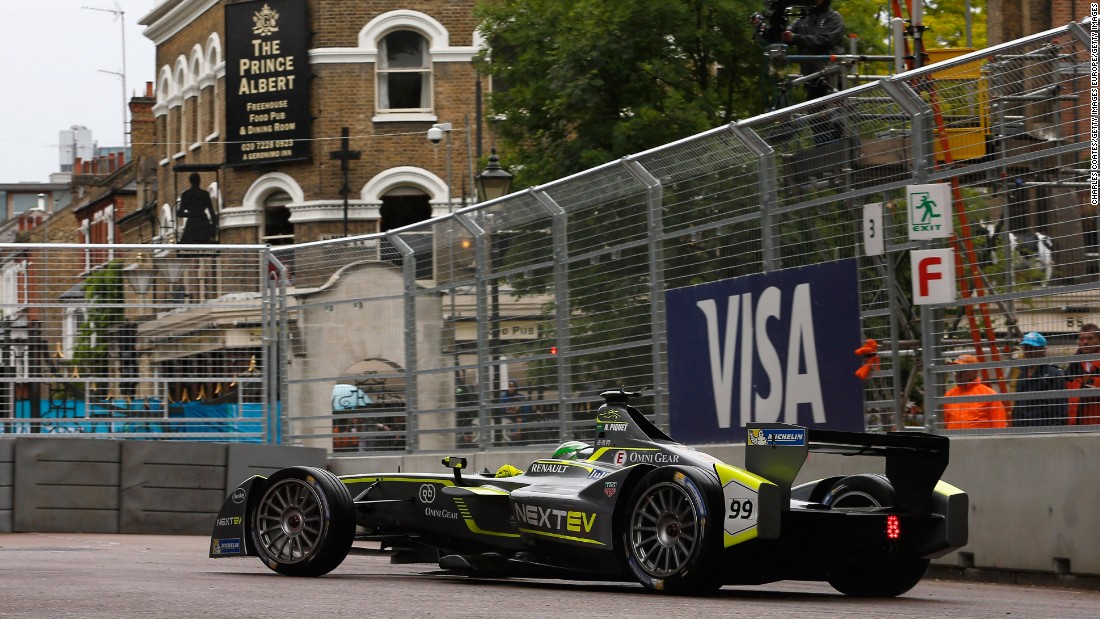 Last year&#39;s championship winner, leader Nelson Piquet of Brazil, takes his car around a corner near a pub on the borders of the Battersea circuit.