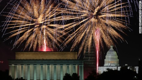 Fireworks light up the sky over the Lincoln Memorial, Washington Monument, and the U.S. Capitol. 