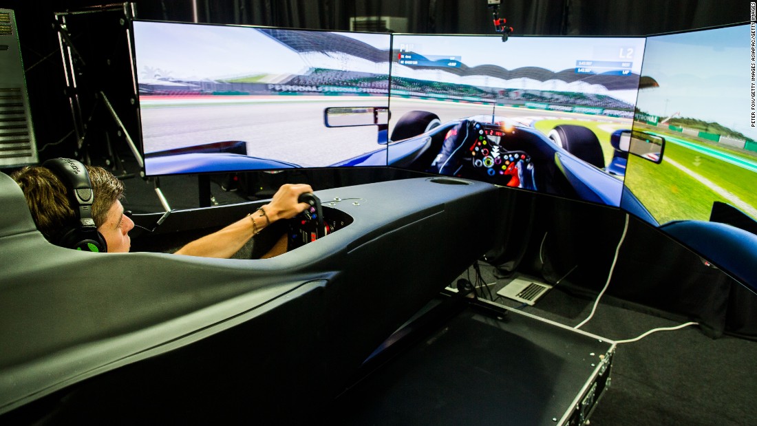 Red Bull driver Max Verstappen tries his hand in the F1 game zone simulator at the 2015 Malaysian Grand Prix.   