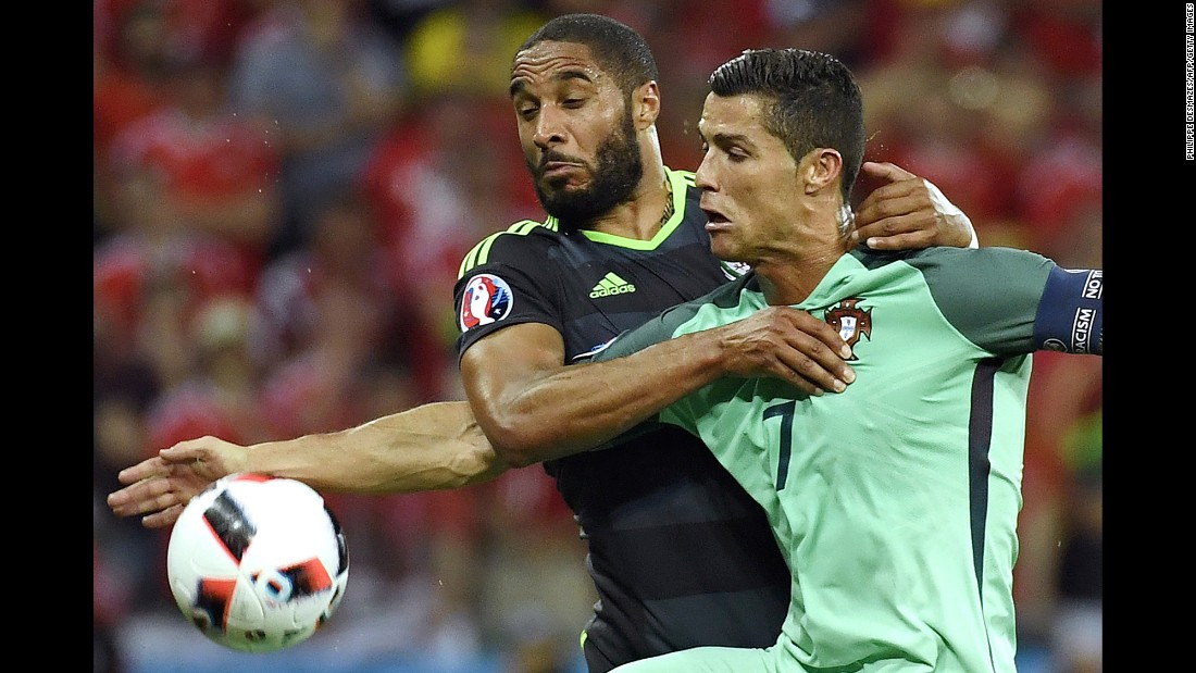 Welsh defender Ashley Williams fights off Ronaldo.