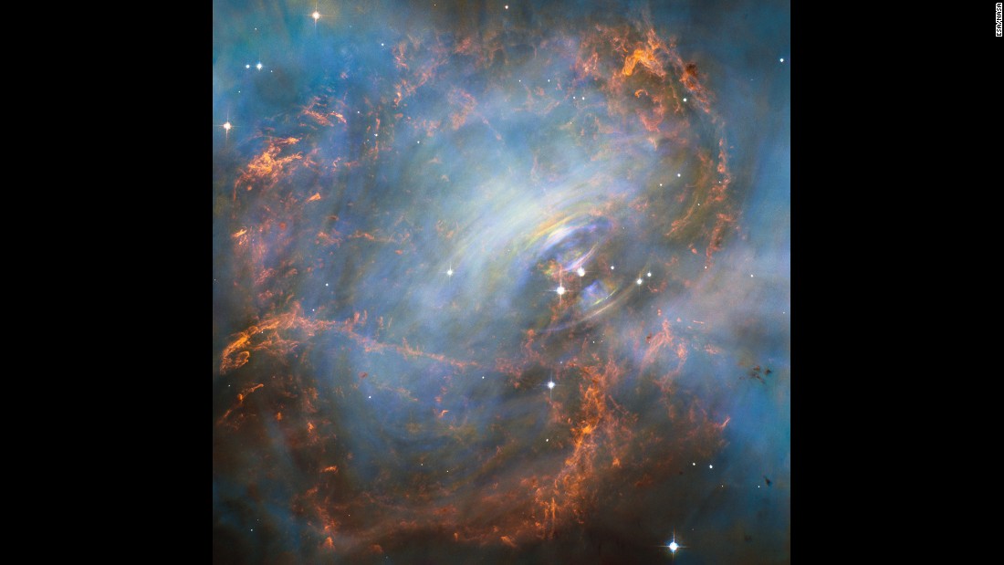 NASA&#39;s Hubble Space Telescope captured this image of the Crab Nebula and its &quot;beating heart,&quot; which is a neutron star at the right of the two bright stars in the center of this image. The neutron star pulses 30 times a second. The rainbow colors are visible due to the movement of materials in the nebula occurring during the time-lapse of the image. 