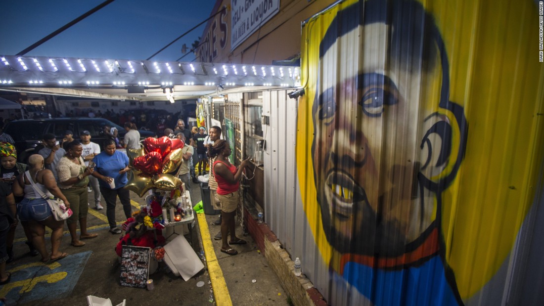 Protesters gather Wednesday, July 6, in front of the convenience store where Alton Sterling was fatally shot in Baton Rouge. Sterling, 37, was shot by police on Tuesday, July 5, and federal authorities are investigating what happened. Vigils and memorials spread across the country after cell phone video of the shooting was shared widely on social media.