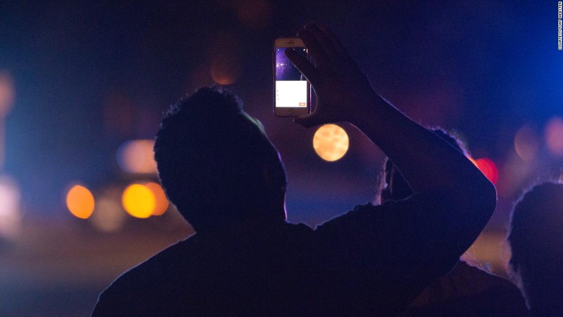 Someone uses their phone to live-stream the  investigation taking place at the scene of Castile&#39;s shooting.