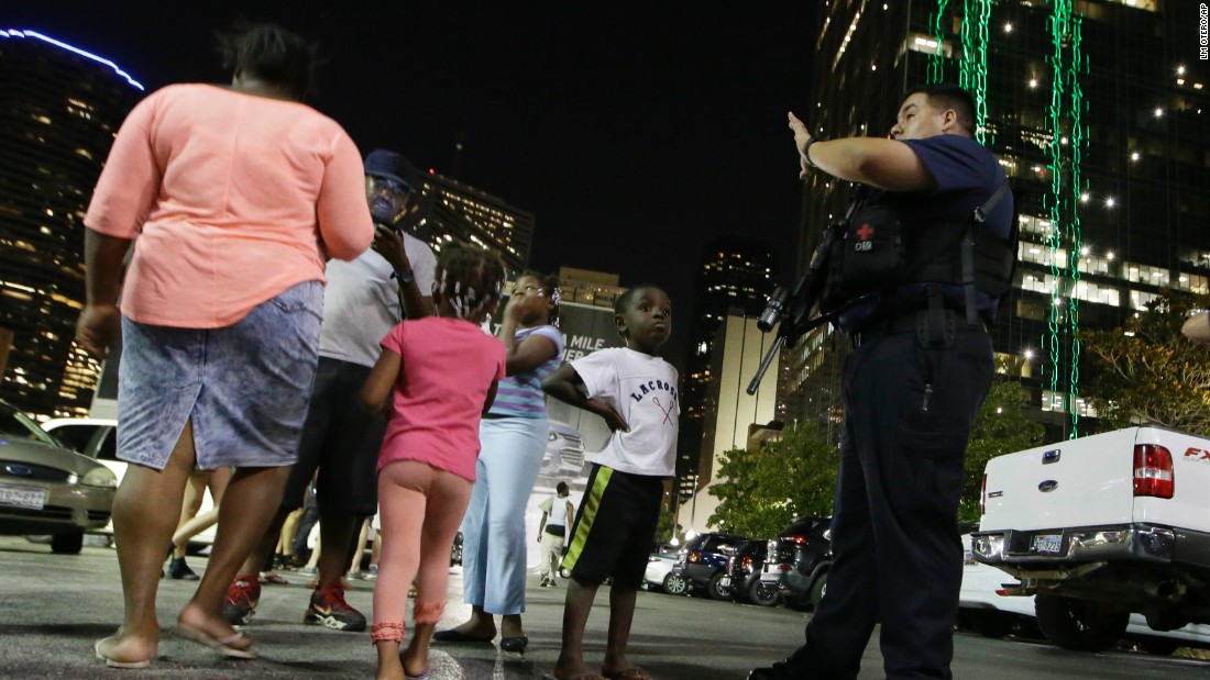 Dallas police order people away from the area after the shootings.