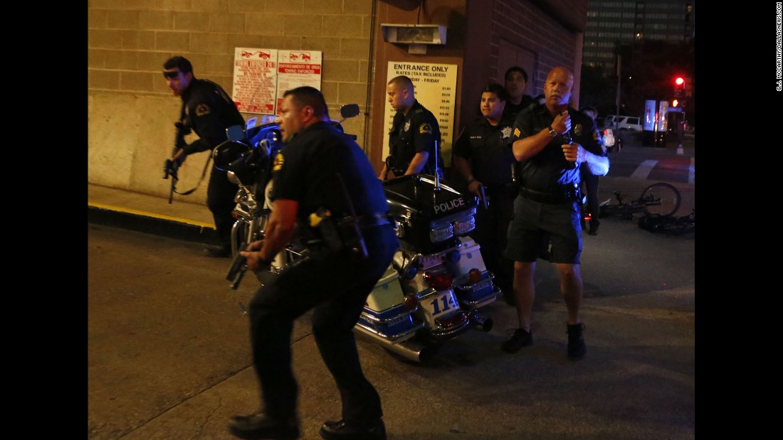 Police get in position after gunshots rang out.