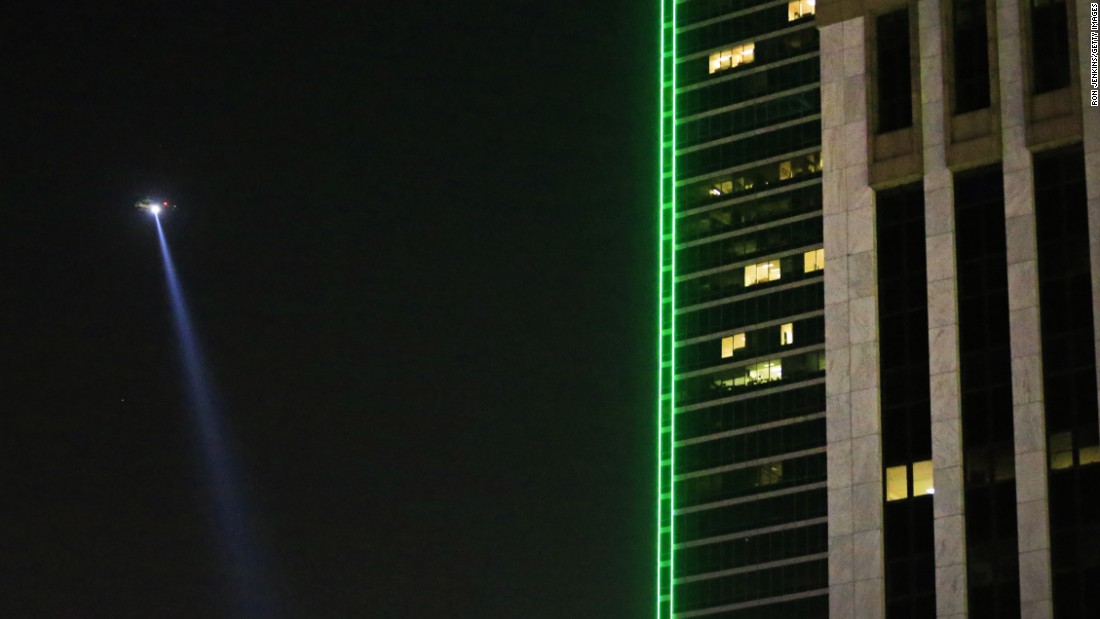 A police helicopter flies over the scene in downtown Dallas. One suspect was killed by police after a standoff that lasted for hours.