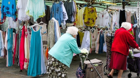 Eldery shooppers peruse the goods at Romford Market.