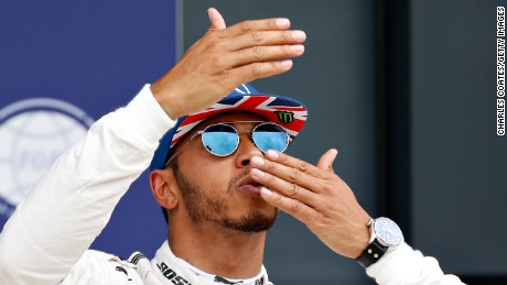 Lewis Hamilton of Great Britain blows kisses to the crowds after qualifying in pole position for Sunday&#39;s British Grand Prix at Silverstone.