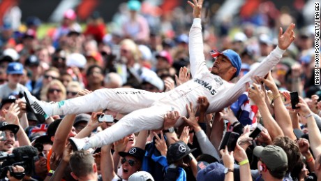 Lewis Hamilton celebrates his British GP win by crowdsurfing with the fans at Silverstone. 