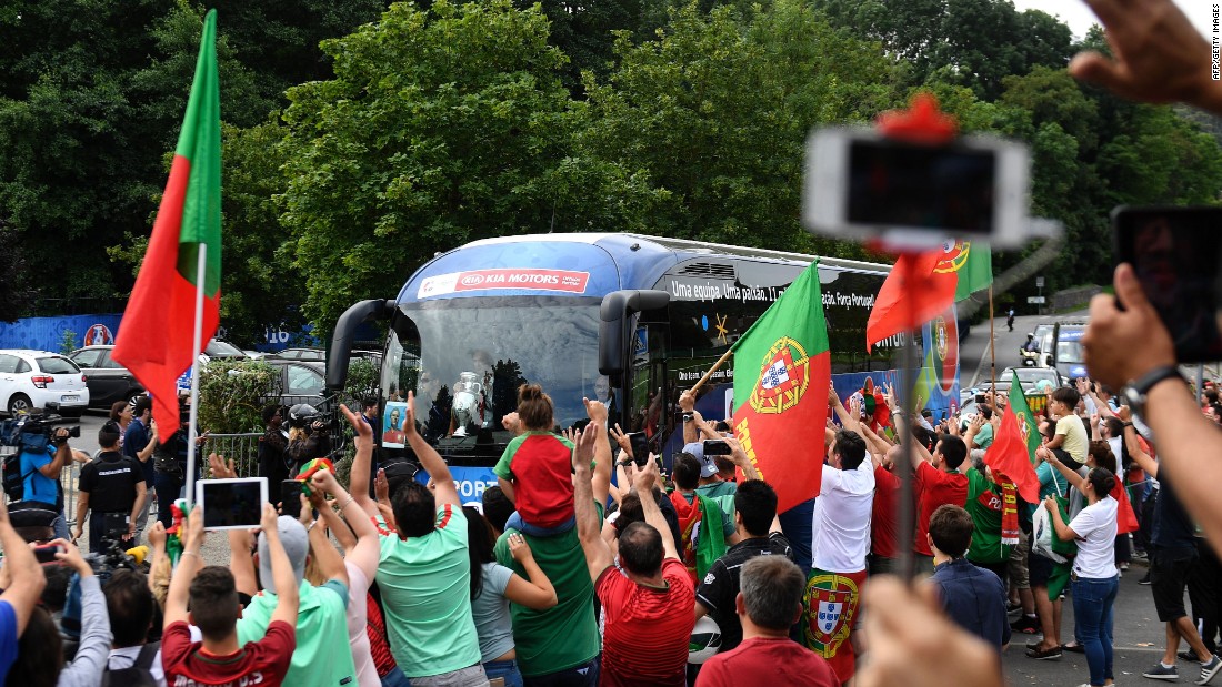 After celebrating long into the night after beating France in the Euro 2016 final, exultant Portugal fans gathered around the team bus as the players left their base camp in Marcoussis to return home. 