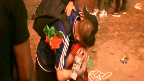Young Portugal fan consoles French fan