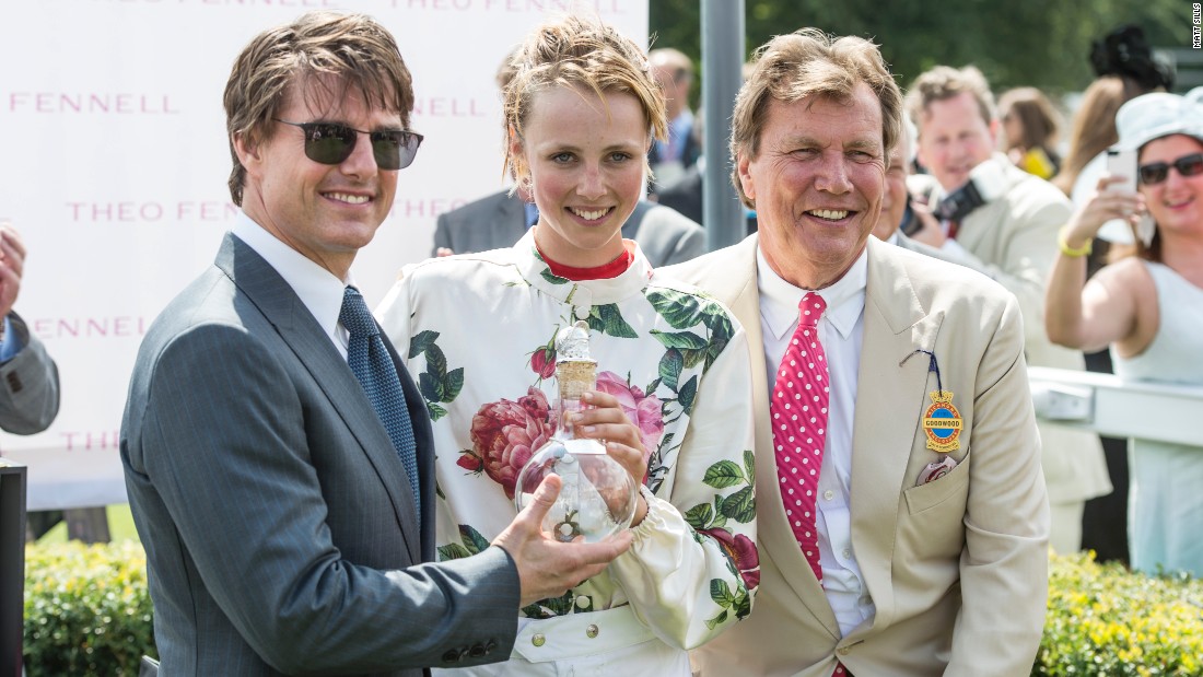 British model Edie Campbell receives the winner&#39;s trophy from film star Tom Cruise in 2014.