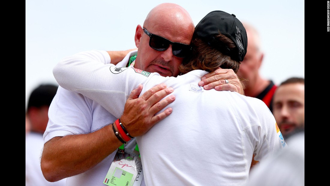 Fernando Alonso of Spain comforts Bianchi&#39;s father Philippe after the family and F1 drivers observed a minute&#39;s silence before the Hungarian GP at the Hungaroring on July 26, 2015 in Budapest, Hungary.