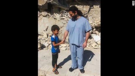  Dr. Samer Attar meeting one of the children who live in the bomb ravaged city.