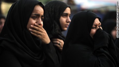 Iraqi women react as people gather on July 9, 2016 at the site of a suicide-bombing attack which took place on July 3 in Baghdad&#39;s Karrada neighbourhood.

The Baghdad bombing claimed by the Islamic State group killed 292 people, according to a new toll issued on July 7, many of whom were trapped in blazing buildings and burned alive. A suicide bomber detonated an explosives-laden minibus early on July 3, ahead of the Eid al-Fitr holiday marking the end of the holy Muslim fasting month of Ramadan. / AFP / AHMAD AL-RUBAYE        (Photo credit should read AHMAD AL-RUBAYE/AFP/Getty Images)
