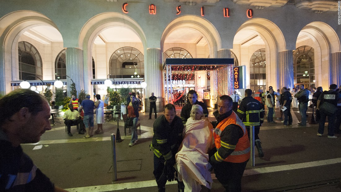 Wounded people are evacuated from the scene where the truck drove into the crowd during the Bastille Day celebrations.