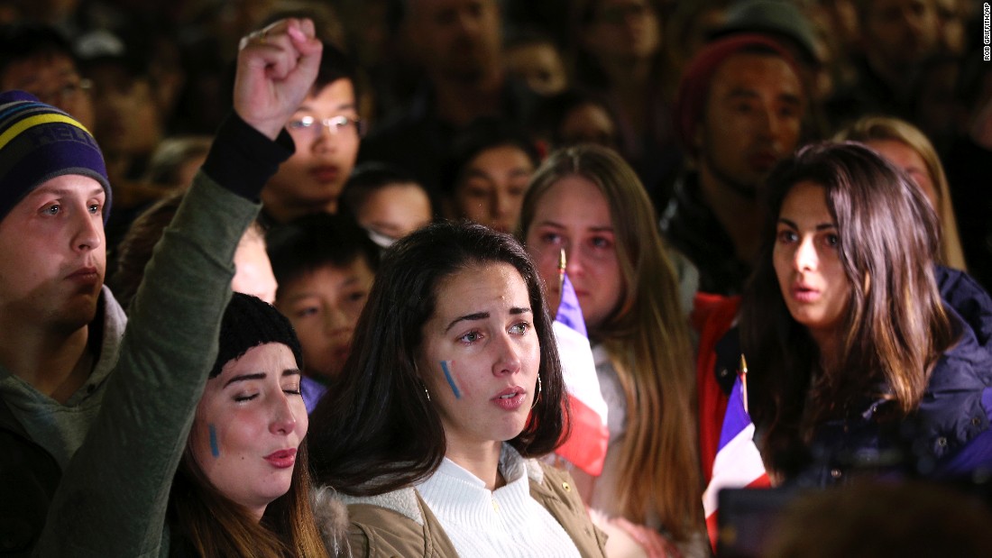 People sing the French national anthem at a July 15 vigil in Sydney.