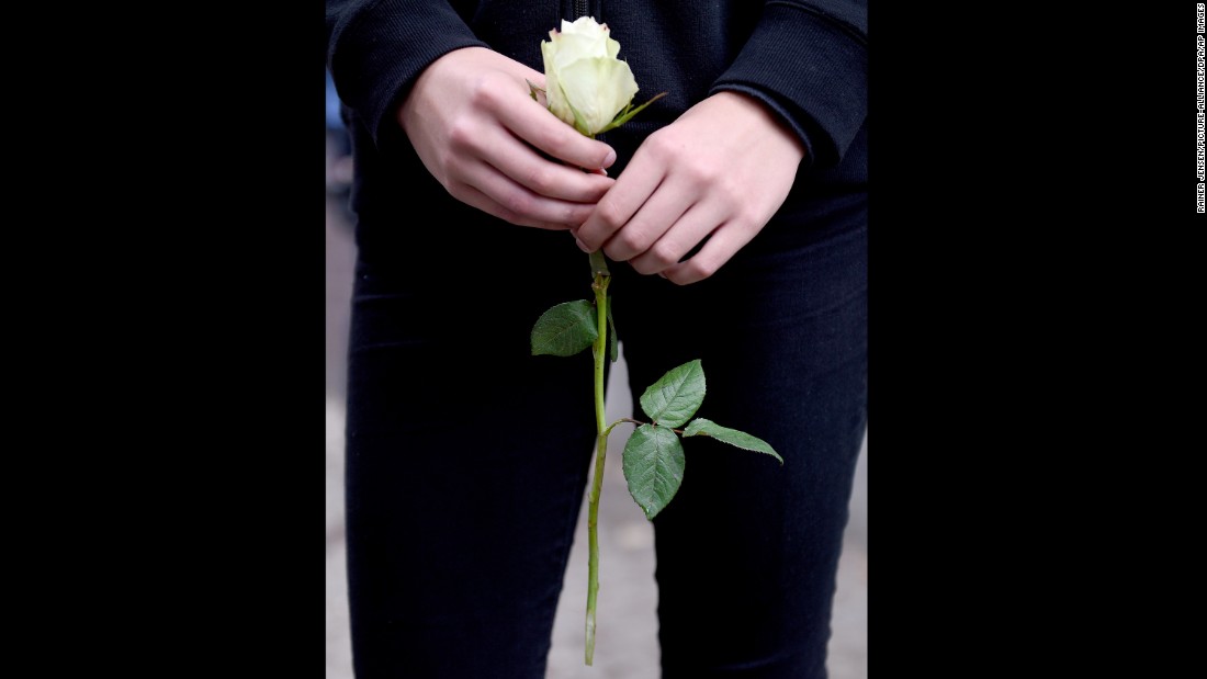 A pupil holds a white rose on the premises of the Paula Fuerst comprehensive school in Berlin, Germany.