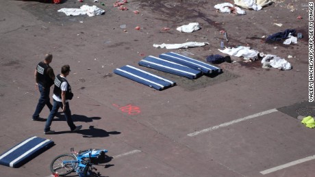 Policemen walk on the site where a truck drove into a crowd watching a fireworks display on the Promenade des Anglais seafront in the French Riviera town of Nice on July 15, 2016.
An attack in Nice where a man rammed a truck into a crowd of people left 84 dead and another 18 in a &quot;critical condition&quot;, interior ministry spokesman Pierre-Henry Brandet said Friday. An unidentified gunman barrelled the truck two kilometres (1.3 miles) through a crowd that had been enjoying a fireworks display for France&#39;s national day before being shot dead by police.
 / AFP / Valery HACHE        (Photo credit should read VALERY HACHE/AFP/Getty Images)