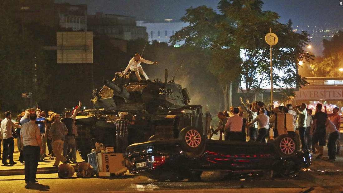 Tanks move into position as Turkish citizens attempt to stop them in Ankara.