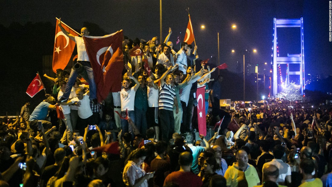 People take to the streets near the Fatih Sultan Mehmet Bridge during clashes with military forces in Istanbul. 