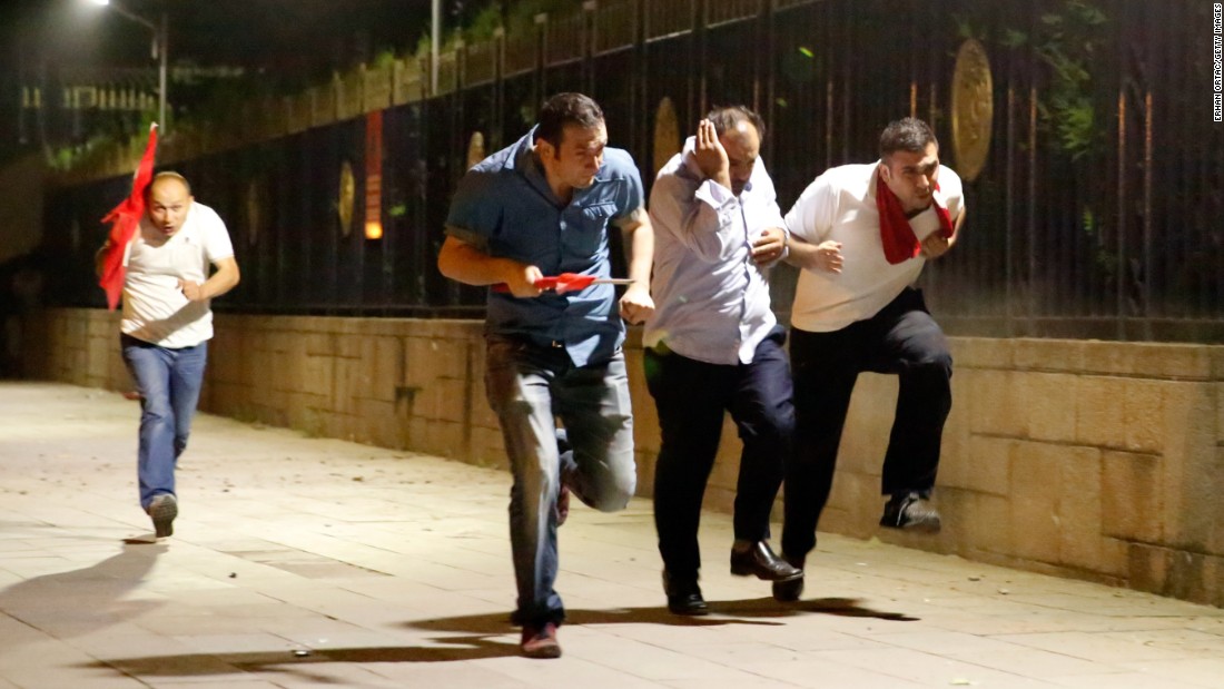 People escape the clashes in Ankara early Saturday. 