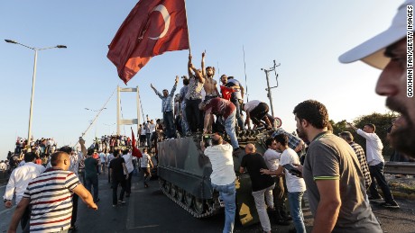 The Turkish President&#39;s supporters celebrate after soldiers surrendered on Istanbul&#39;s Bosphorus Bridge.