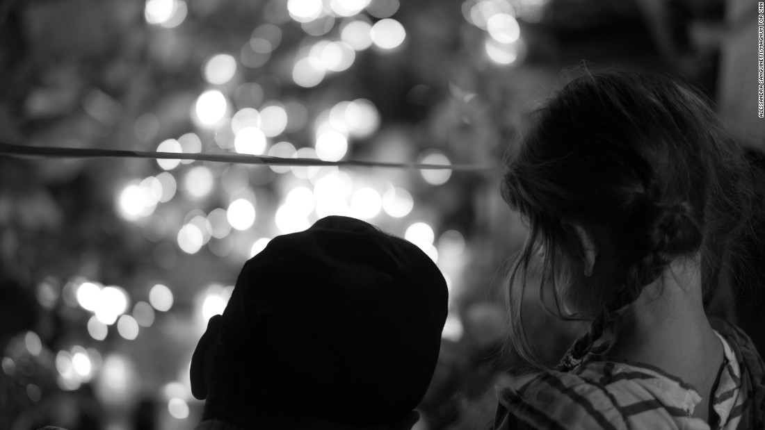 A man and a child look at a memorial for victims of the attack. Sanguinetti spent time photographing near the Promenade des Anglais, the area where the tragedy unfolded.