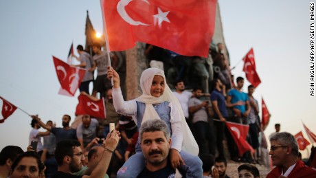 People wave flags in Istanbul&#39;s Taksim Square on Saturday in support of  the President. 