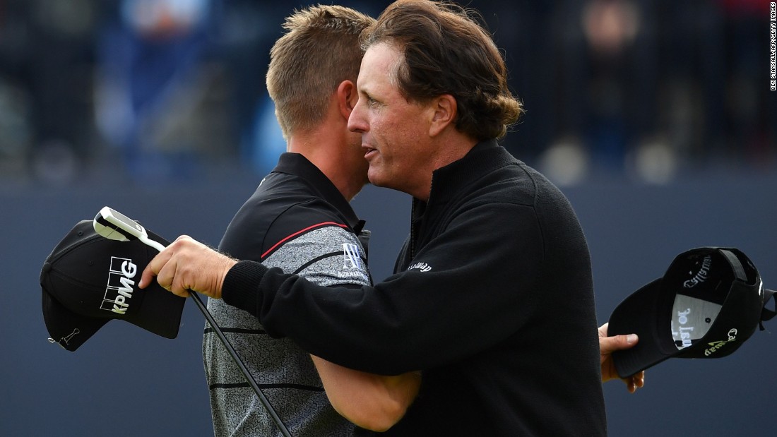 Stenson and Mickelson embrace after their incredible final round showing with the Swede equaling the major championship record round with an eight-under 63. Mickelson shot a 65. 