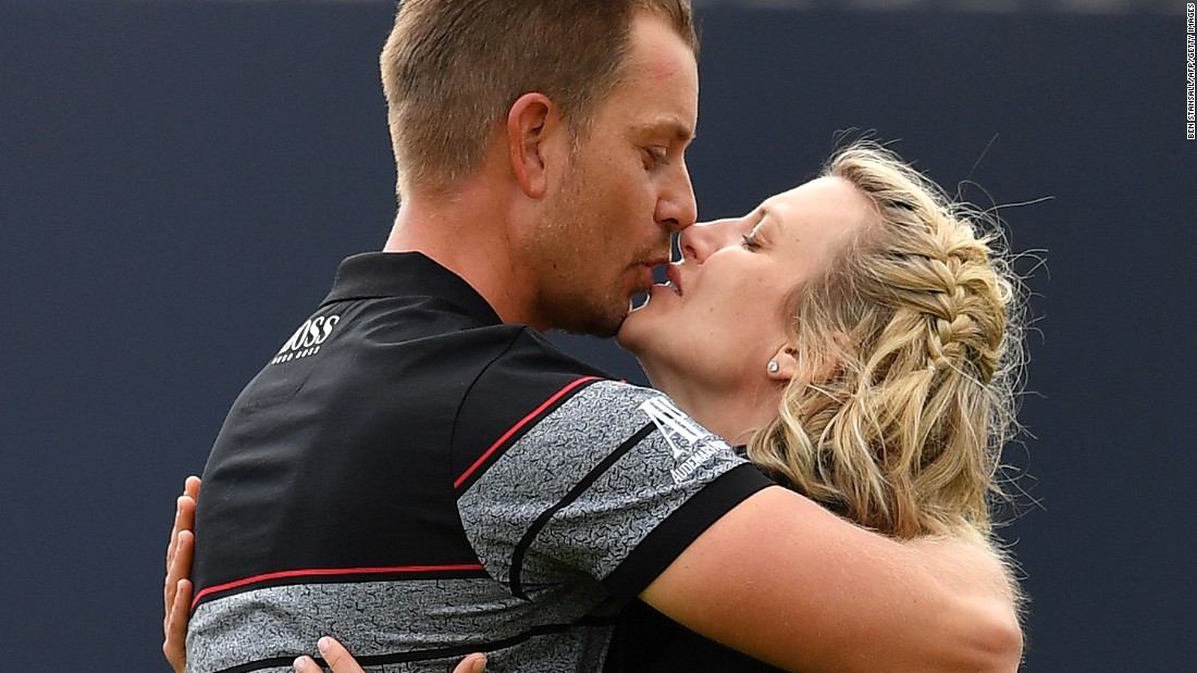 Stenson kisses his wife Emma on the 18th green after sealing his victory and first major.