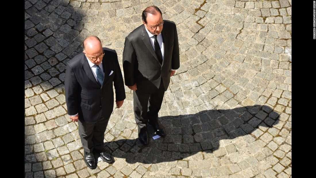 French President Francois Hollande, right, and Interior Minister Bernard Cazeneuve take part in the observation of a minute&#39;s silence on July 18 at the Interior Ministry in Paris.