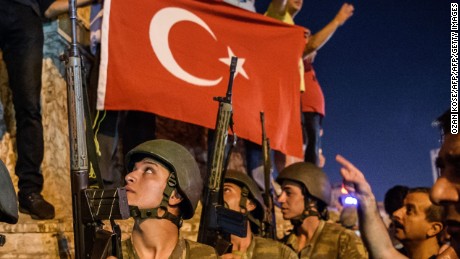 Turkish solders stay with weapons at Taksim square as people protest against the military coup in Istanbul.