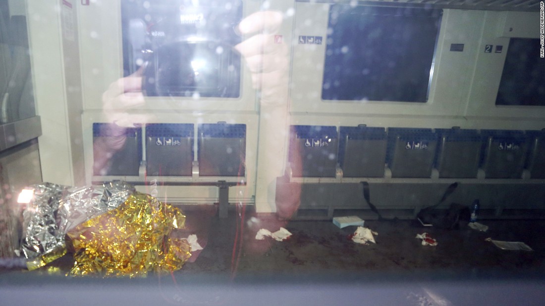 Blood stains and a rescue blanket appear through the windows of the train in Wurzburg. The attacker was identified as a 17-year-old Afghan man living in Ochsenfurt, Germany.