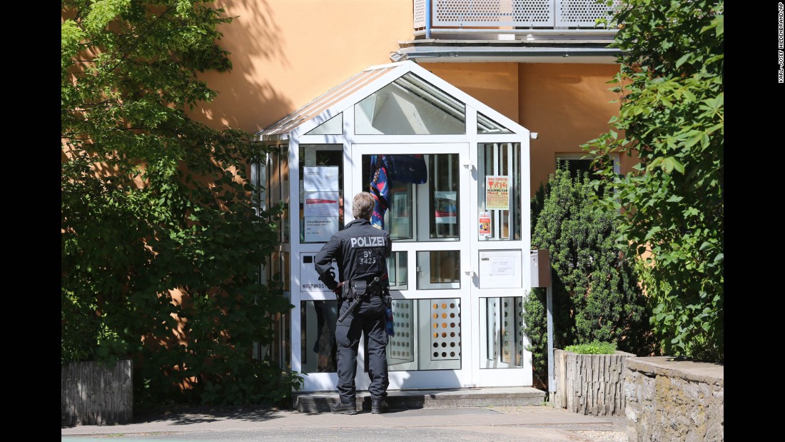A police officer enters the Kolping House in Ochsenfurt on Tuesday, July 19, where the attacker reportedly lived with other refugees until two weeks ago. The attacker came to Germany without his parents a year ago,  police said.
