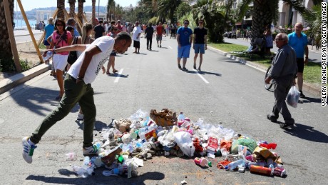 A man spits on the site in Nice where police killed the attacker.