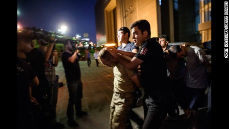 Turkish anti-riot police officers in Istanbul escort soldiers accused of taking party in a military coup that failed over the weekend.