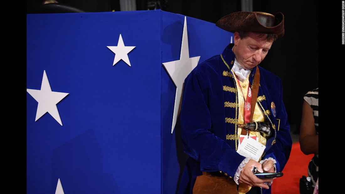 A delegate checks his phone at the arena.