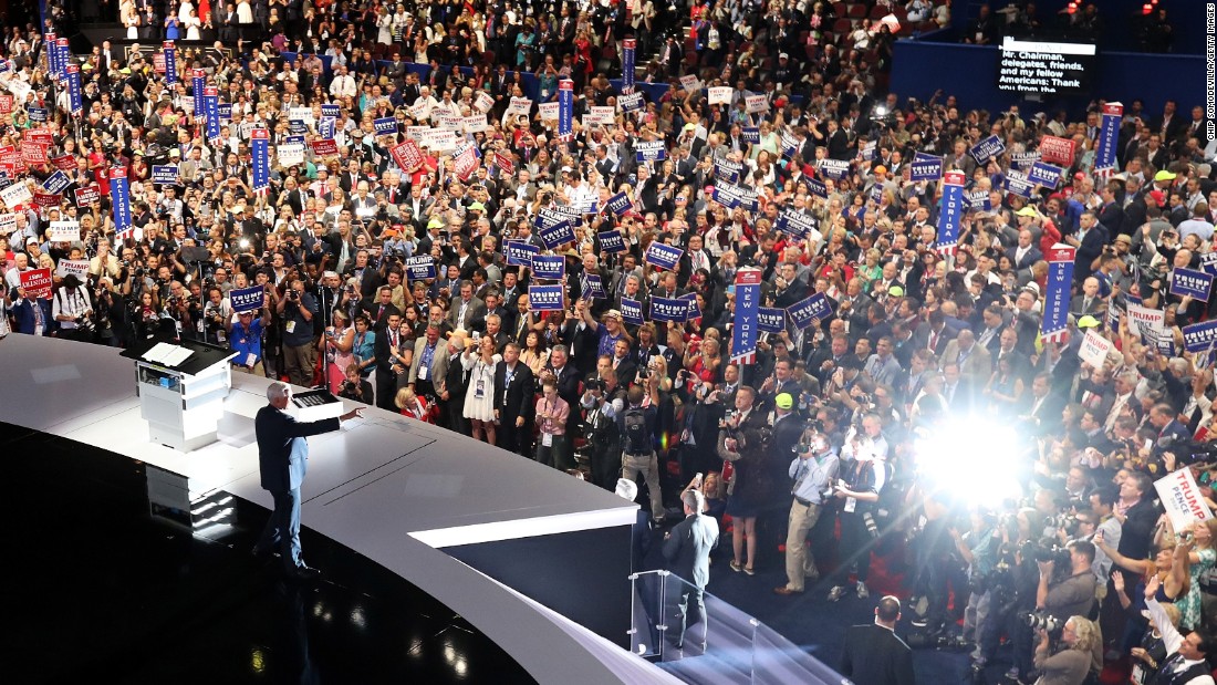 Pence acknowledges the crowd as he walks on stage to deliver his speech.