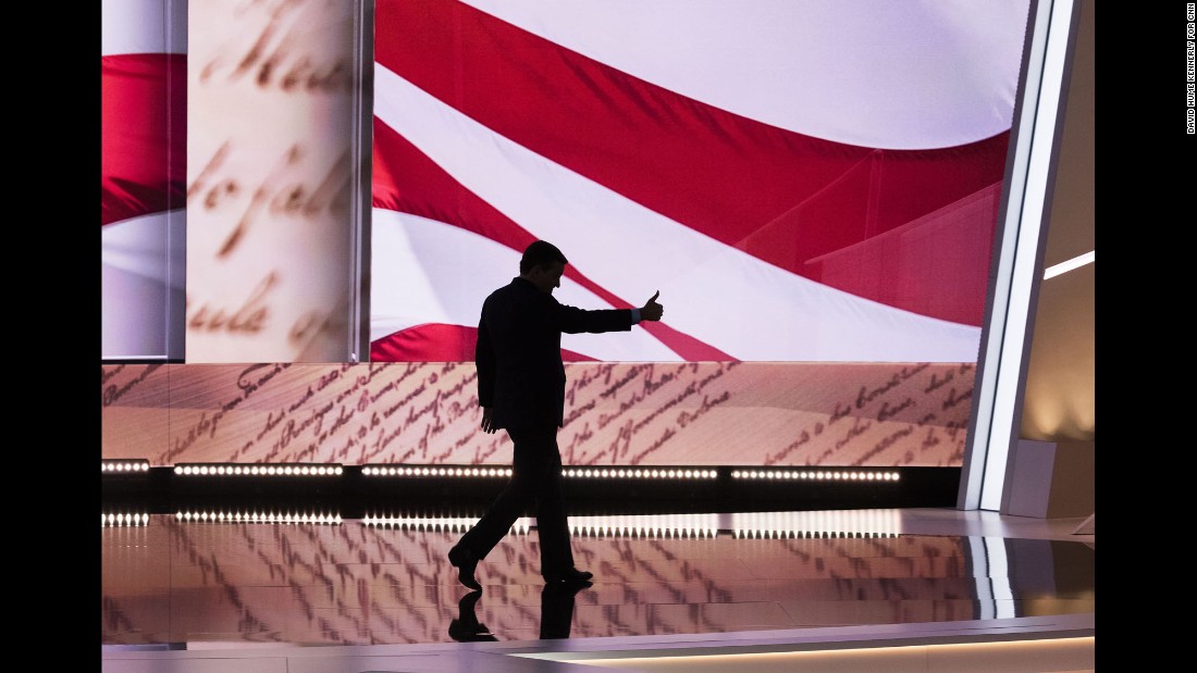 Cruz gives a thumbs-up as he walks off stage.