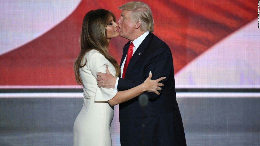 The Trumps embrace on stage.